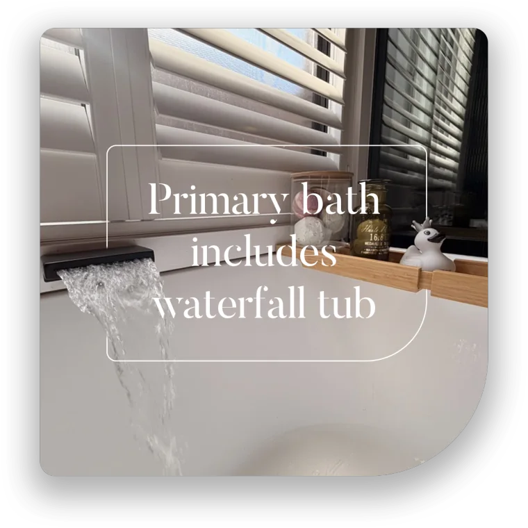 Soaking tub with waterfall spout in the primary ensuite